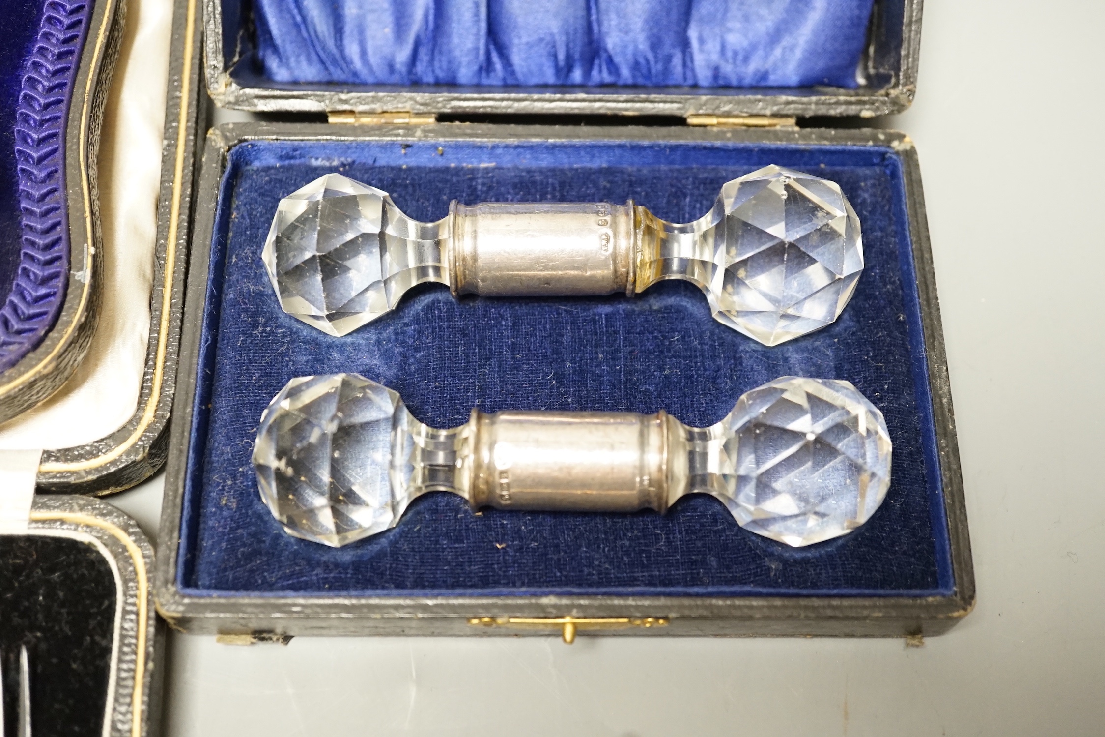 Two 18th century silver 'berry' spoons in associated case and three other cased sets including, pair of silver mounted glass knife rests, a cased set of six seal top coffee spoons and a part set of dessert eaters.